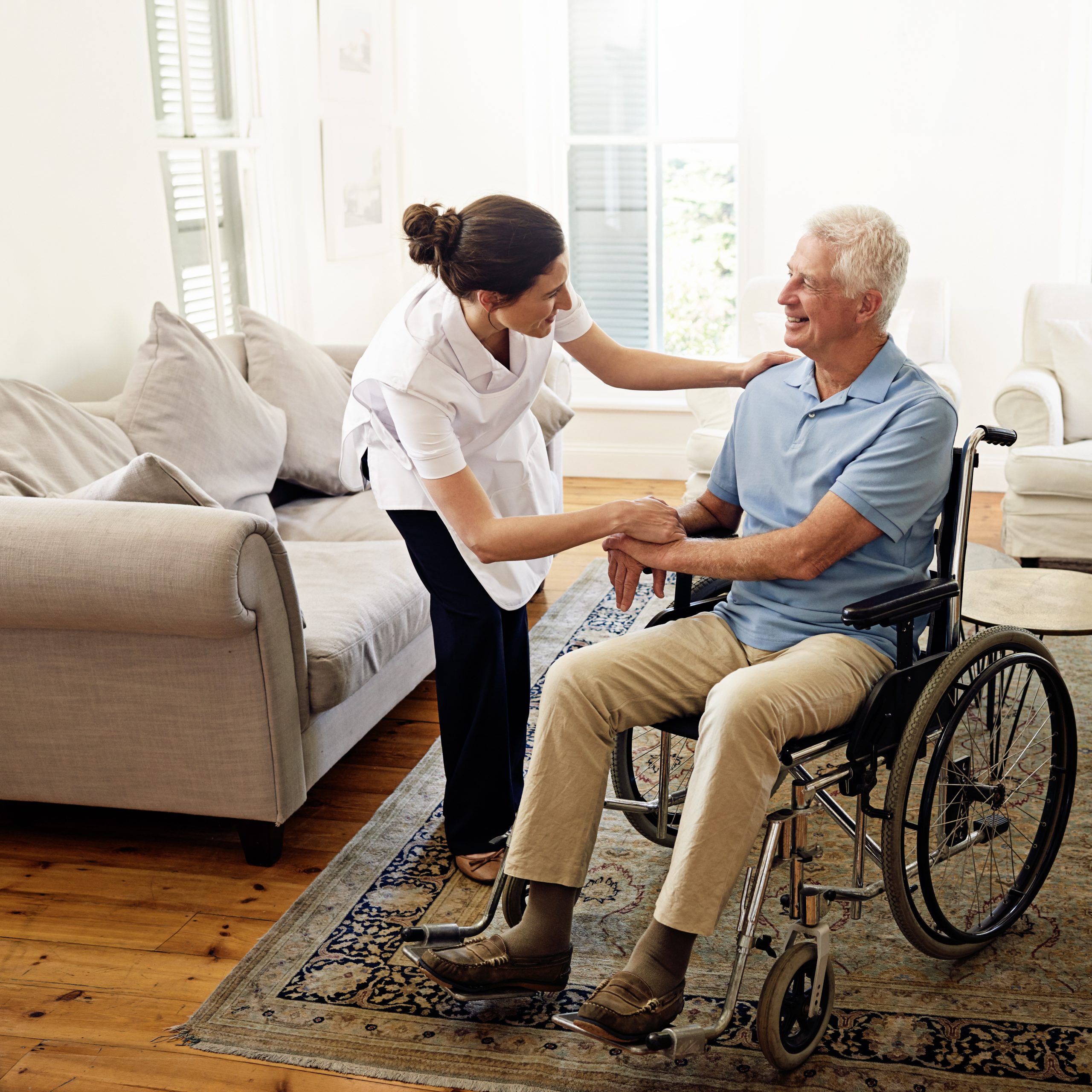 North Charlotte NC Home Care caretaker consoling man in wheelchair