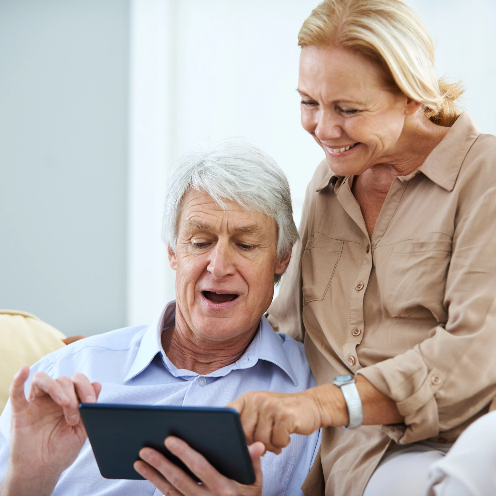 Home Care Shelby NC mature caretaker showing ipad to elderly man